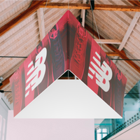 A hanging trade show display with branding, suspended from a ceiling in an indoor setting.
